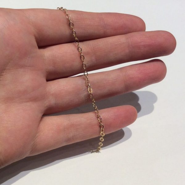 gold fill flat oval chain 765F in hand to show scale