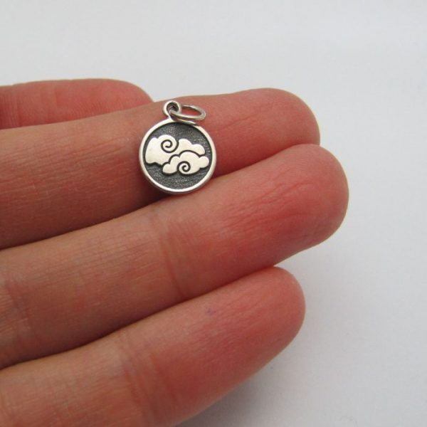 air element tag front of charm sterling silver in hand to show scale